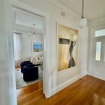 Interior hallway repaint in Drummoyne leading into living room with timber floors