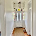 Heritage entry hallway repaint in Drummoyne with stained glass door and white walls