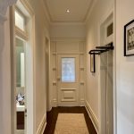 Interior hallway repaint in Drummoyne with clean white walls, detailed trim and heritage features