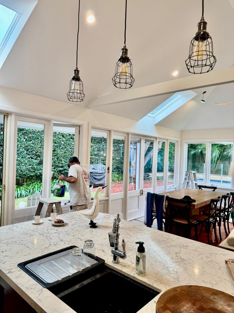 Bright kitchen and dining area repaint in Drummoyne with white walls and large windows