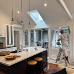 Interior painting in Drummoyne kitchen extension with painter working on doors and trim