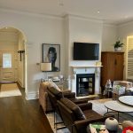 Living room repaint in Drummoyne with neutral colours, restored fireplace and timber flooring