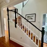 Staircase repaint in Drummoyne with white balustrades and dark timber handrail