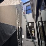 Exterior wall painting in narrow access area of Glebe terrace