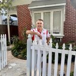 Painter working on heritage front fence repaint in Marrickville terrace
