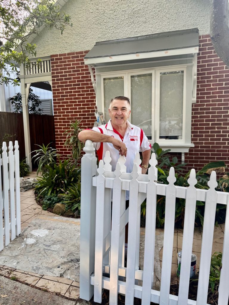 Painter working on heritage front fence repaint in Marrickville terrace