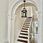 Heritage hallway repaint in Petersham with ornate arch and staircase detail