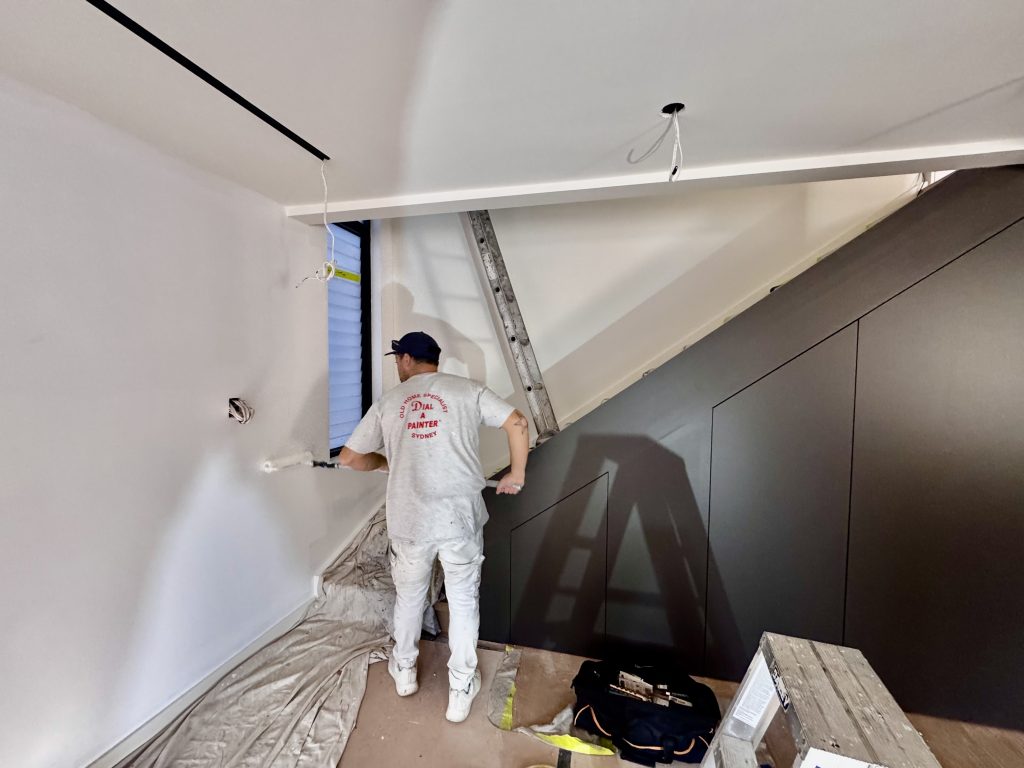 Interior painter completing stairwell and custom wall painting works in Enmore NSW