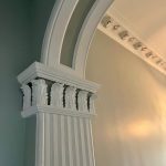 Heritage archway and column detail with decorative plasterwork in hallway