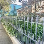 Restored cast iron fence in front of heritage home in Dulwich Hill