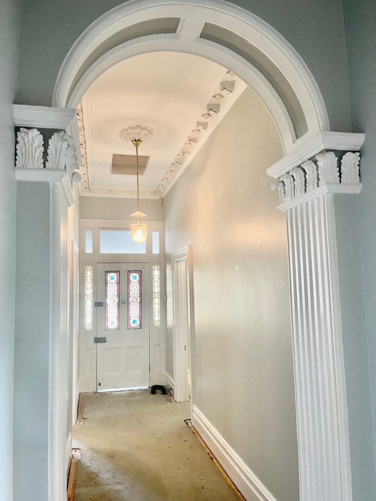 Finished hallway with heritage archway and restored detailing in Dulwich Hill