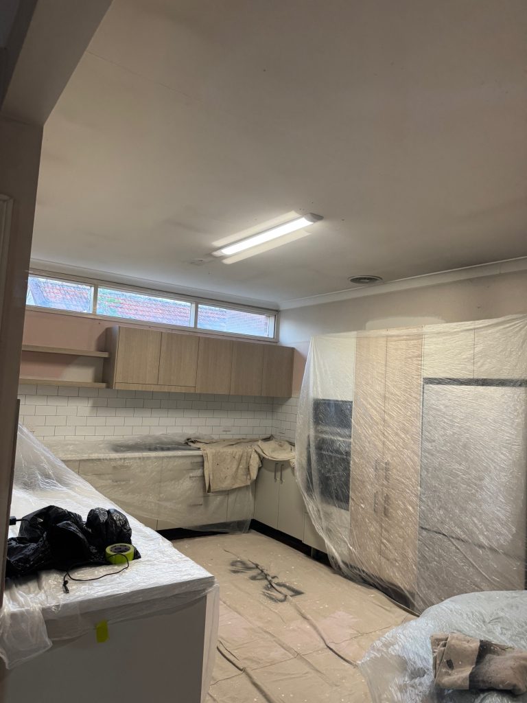Kitchen preparation and protection work before interior repainting project in Five Dock NSW