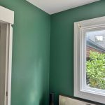 Green feature wall painting with white trim in Enmore residential home