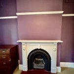 Heritage fireplace with feature wall painting and decorative mouldings in Enmore home