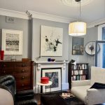 Living room painting with decorative ceiling rose and fireplace in Enmore home