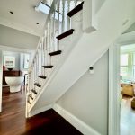 Interior staircase painting with white balustrades and timber flooring in Enmore home