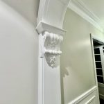 Decorative arch detail in Ashbury home with ornate mouldings and detailed interior paint finishes