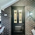 Front entrance door in Ashbury home with decorative stained glass and detailed painted timber finishes