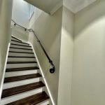 Interior staircase detail in Ashbury home with painted walls, timber stairs and handrail finishes