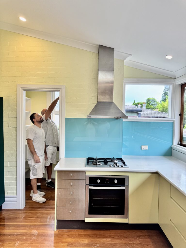 Painters completing kitchen painting work in heritage home at Summer Hill NSW