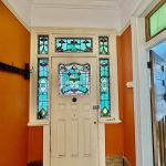 Heritage stained glass entry and decorative hallway features in Summer Hill home